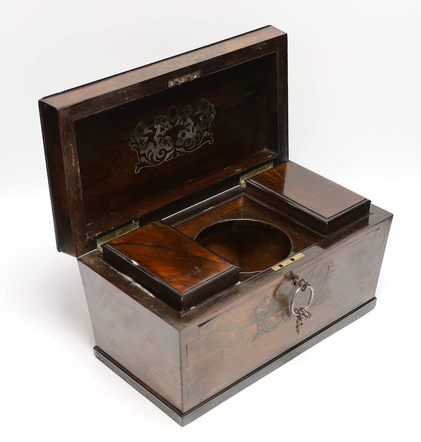 A George IV cut brass inlaid rosewood sarcophagus tea caddy, with keys, 32cm wide